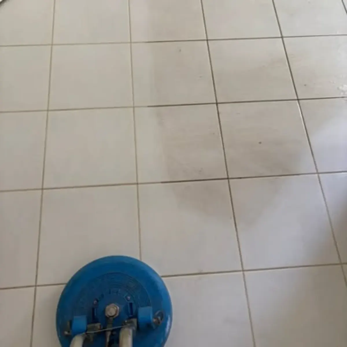Professional tile and grout cleaning machine on white floor tiles by Shepp City Carpet Cleaning